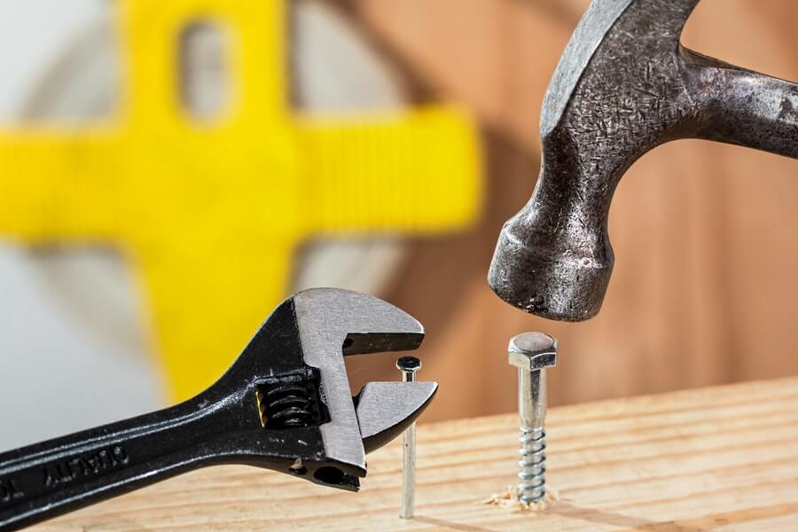 Hammering a screw while tightening a nail.