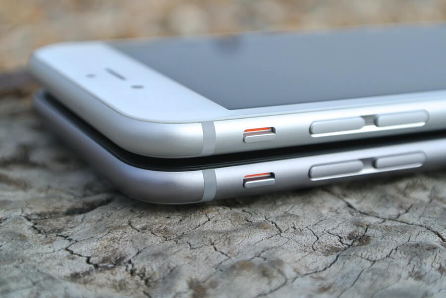 Two iPhone 6's (white and grey) neatly stacked on top of each other.
