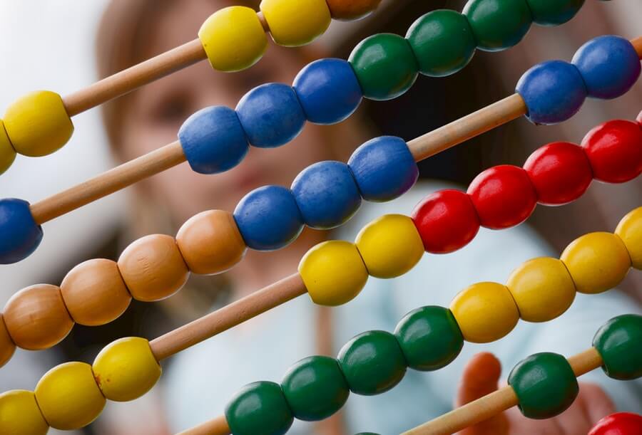 A child does heavy maths on an abacus.
