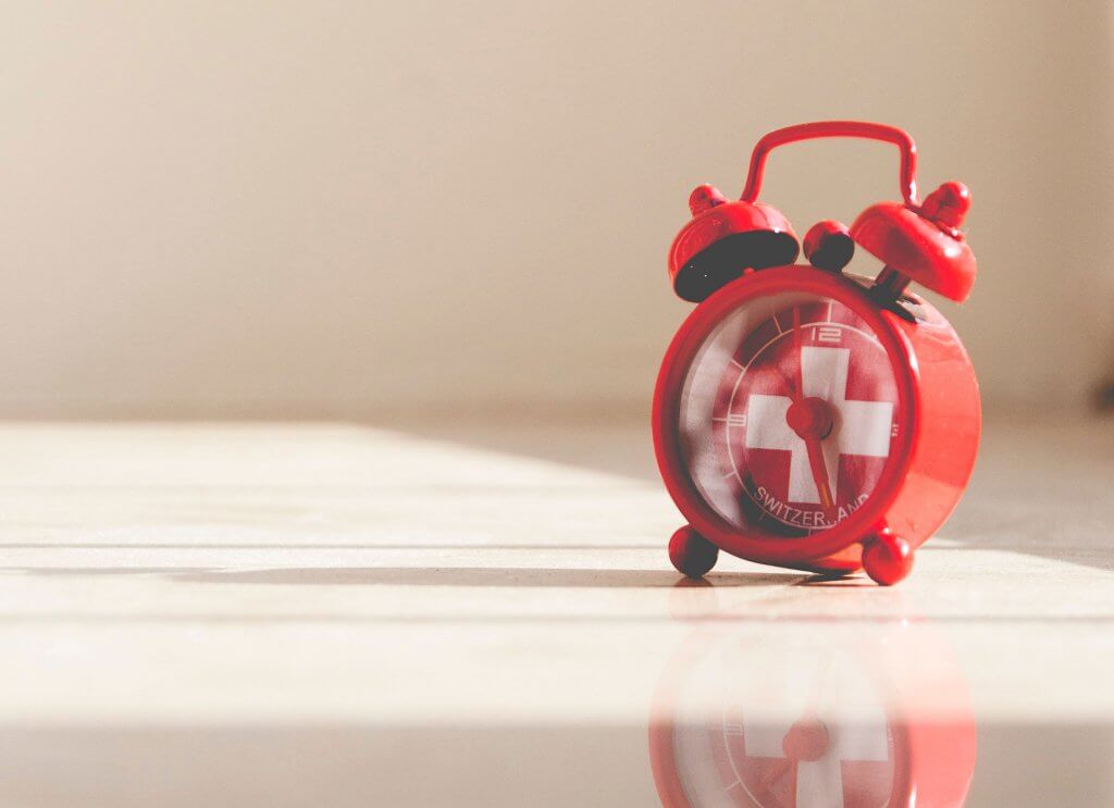 Clock with Swiss flag.