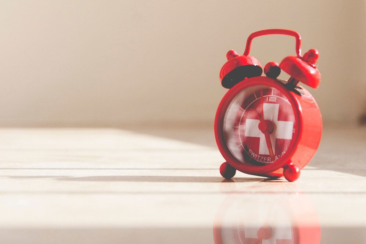 Clock with Swiss flag.