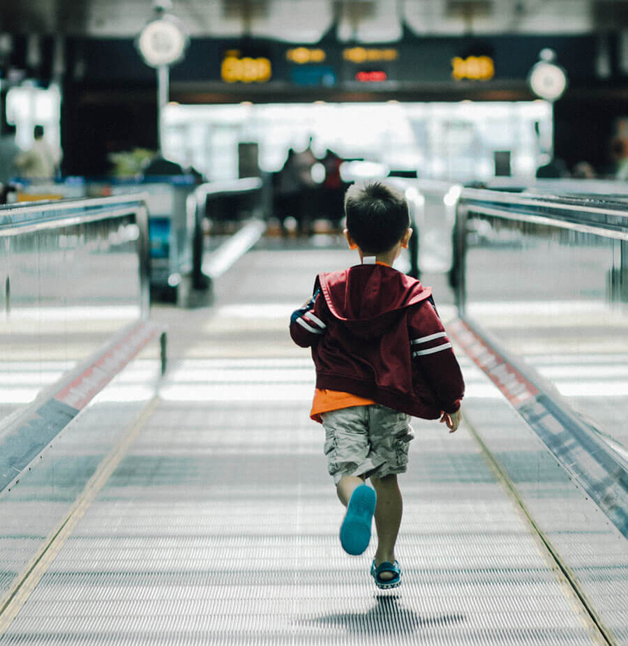A little boy running loose in Singapore's Changi Airport.