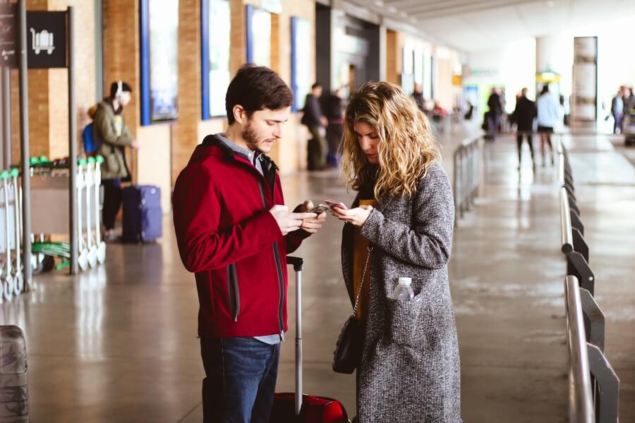 A man and a woman waiting at the airport, probably for Bob.