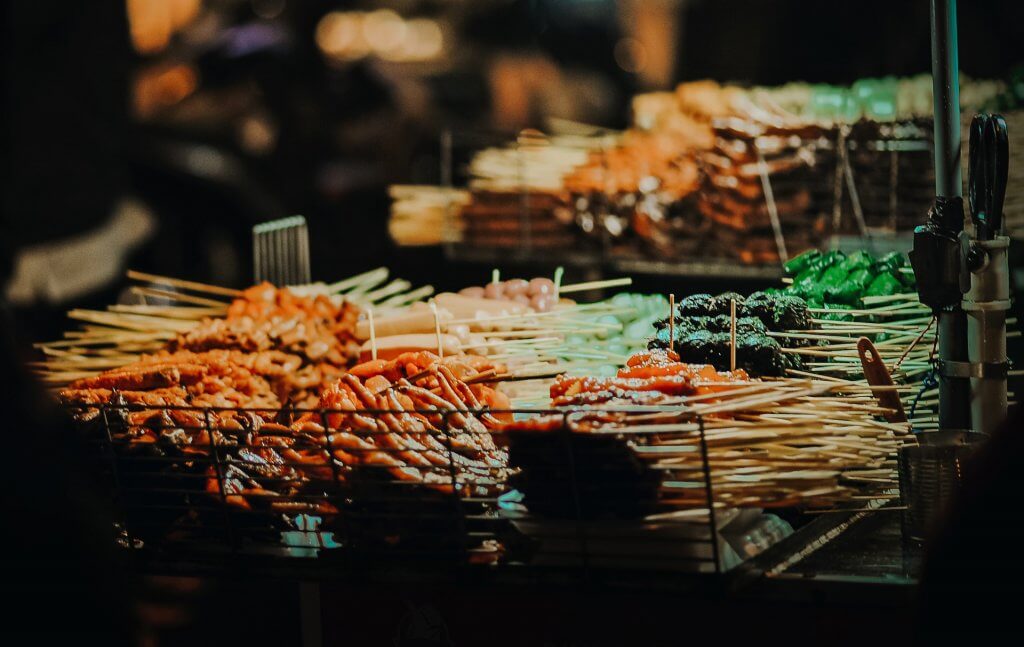 Various street foods at an outdoor market - from chicken feet to fish balls, and a whole lot more.