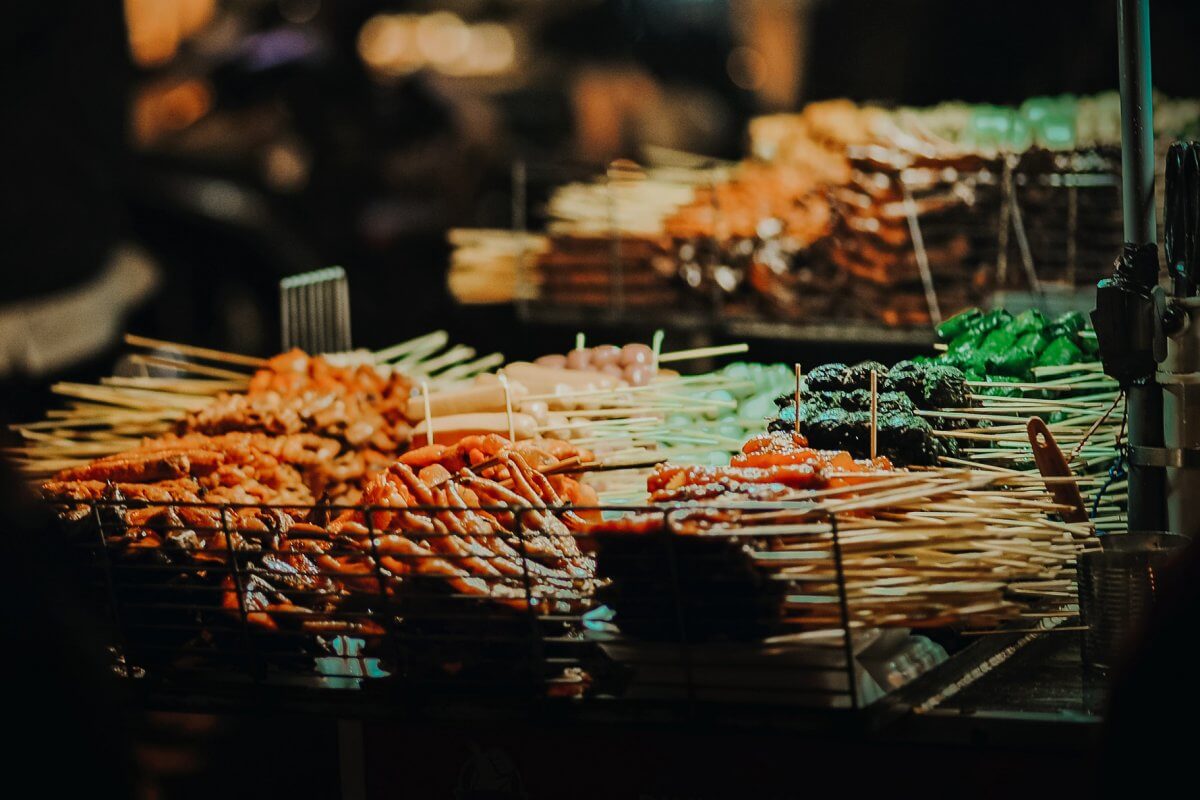 Various street foods at an outdoor market - from chicken feet to fish balls, and a whole lot more.