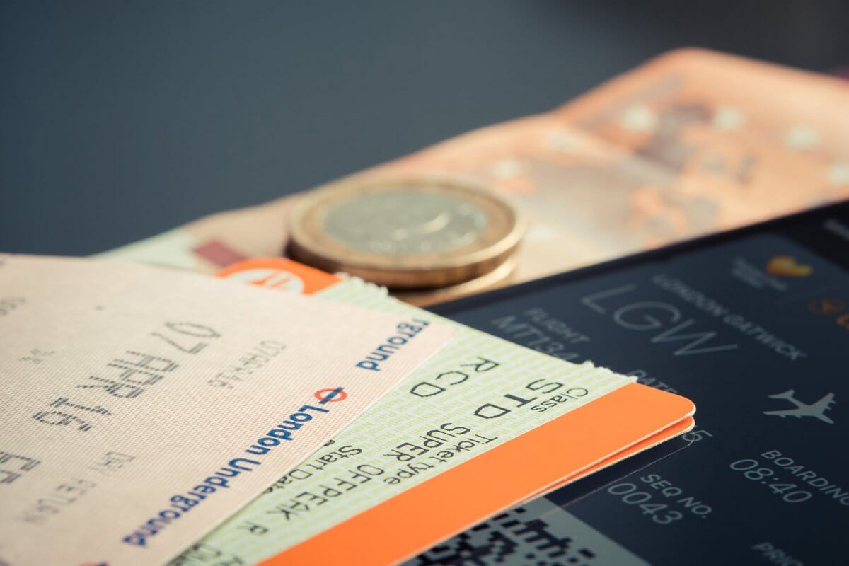 Physical and digital plane tickets with cash.